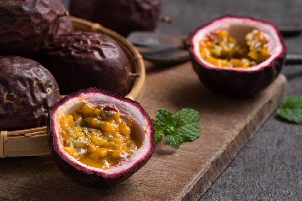 Close up of delicious juicy fresh passion fruit on gray table background.