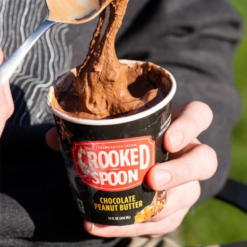 person eating crooked spoon ice cream with a spoon